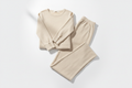 Luxurious women's loungewear set in neutral tones on a white background