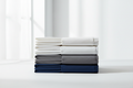 Cotton bed sheets in white, gray, and navy blue